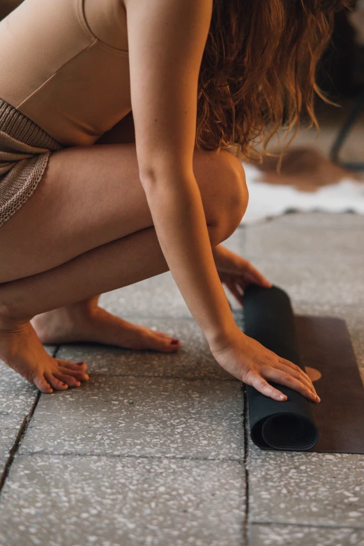 a woman kneeling on the ground with a yoga mat, unsplash, renaissance, square, brown, low detail, neoprene