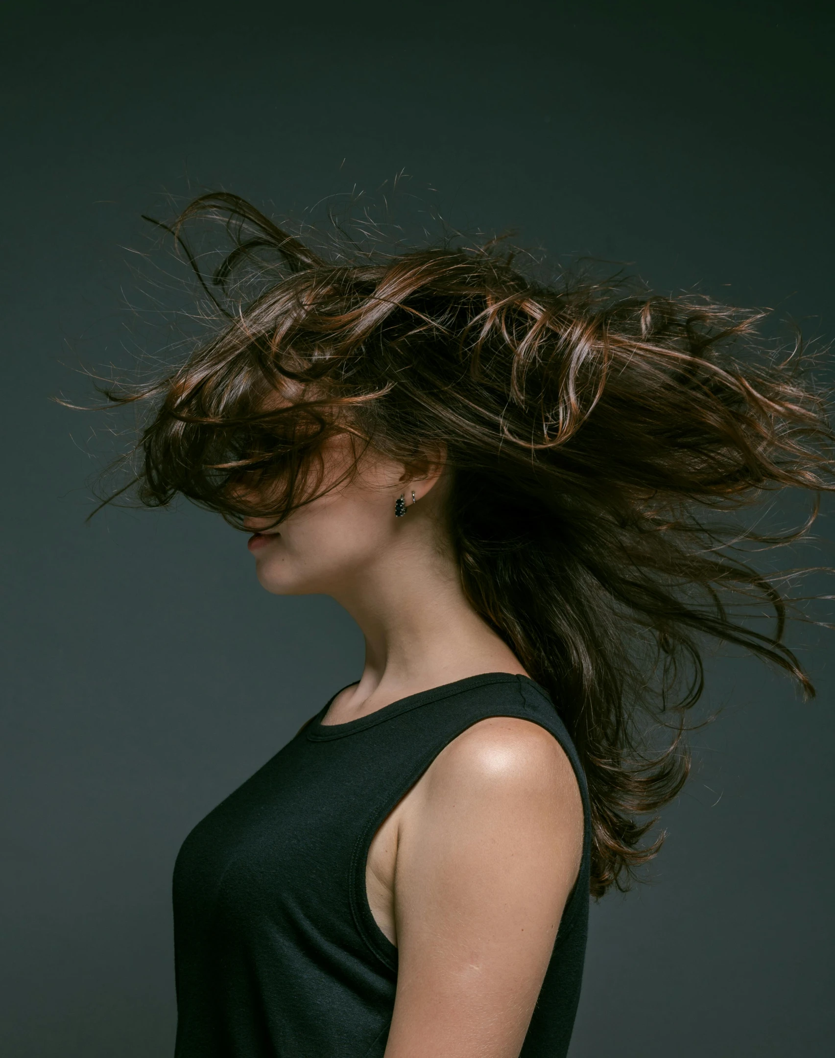 a woman with her hair blowing in the wind, an album cover, trending on unsplash, studio shoot, brown hair flow, profile image, trending photo