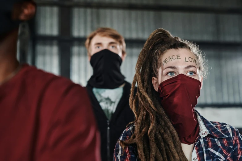 a woman with dreadlocks wearing a face mask, antipodeans, photograph of three ravers, in a warehouse, protest, avatar image