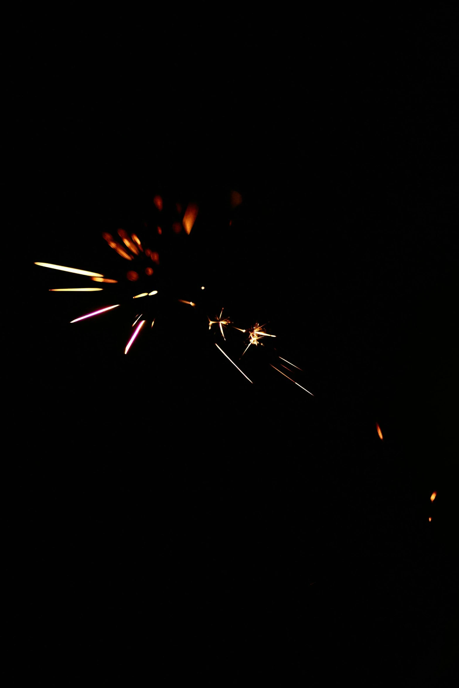 a firework is lit up in the dark, taken on iphone 14 pro, profile image, digital image, large)}]