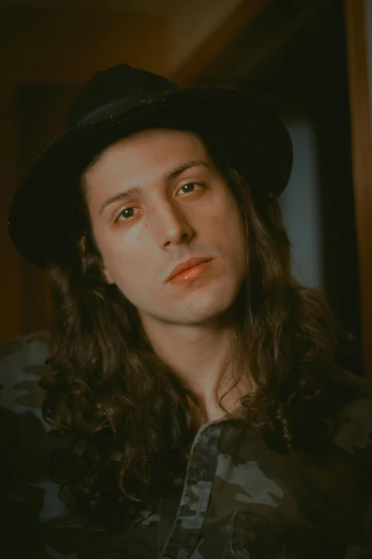 a man with long hair wearing a hat, an album cover, inspired by Anthony Palumbo, trending on pexels, androgynous face, ✨🕌🌙, kailee mandel, in 1 9 9 5