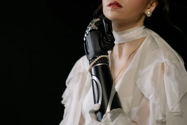 a woman in a white dress and black gloves, unsplash, art nouveau, prosthetic arm, wrapped in black, portrait image