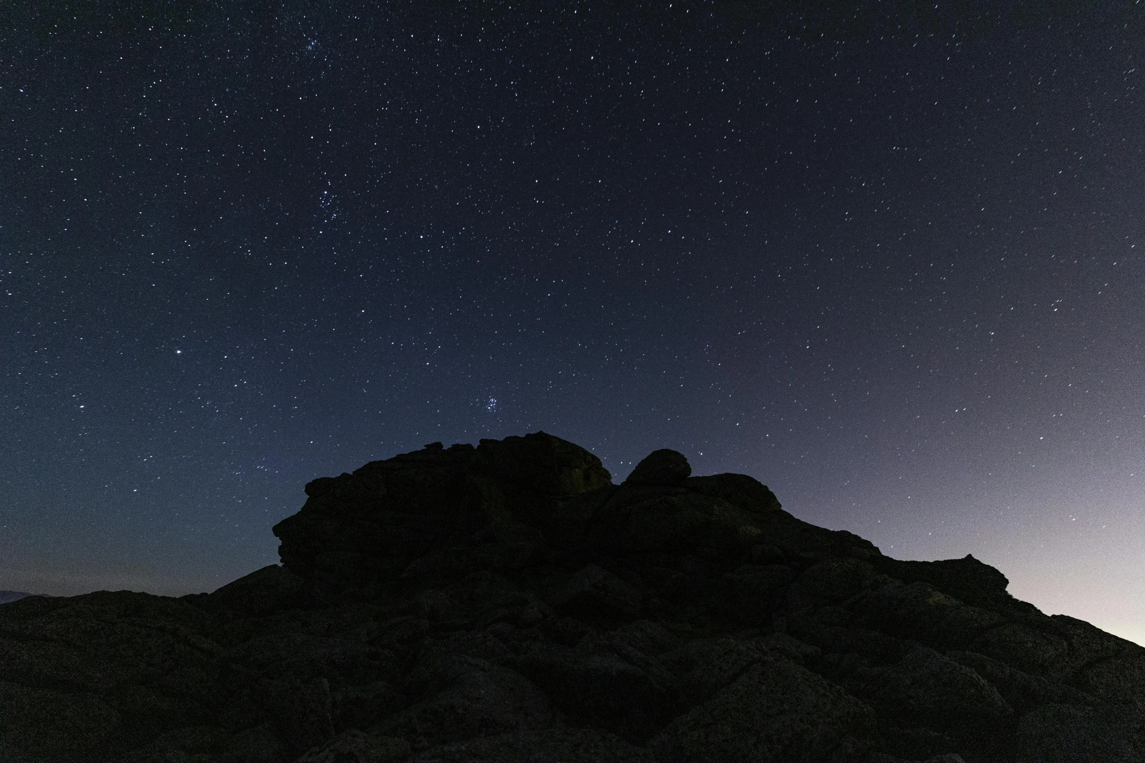 a group of people standing on top of a mountain under a night sky, rocks, low quality photo, illustration », timelapse