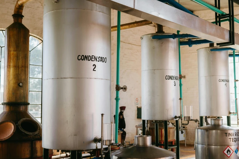 a group of metal tanks sitting inside of a building, inspired by Ceferí Olivé, trending on unsplash, cooking oil, coban, conde nast traveler photo, instagram story