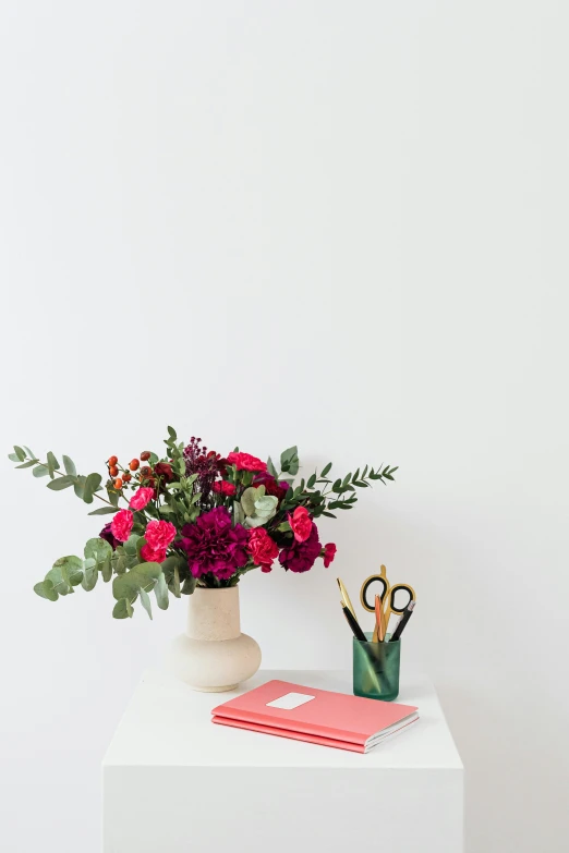 a white table topped with a vase filled with flowers, a still life, trending on pexels, magenta and gray, with notes, product introduction photo, viridian and venetian red