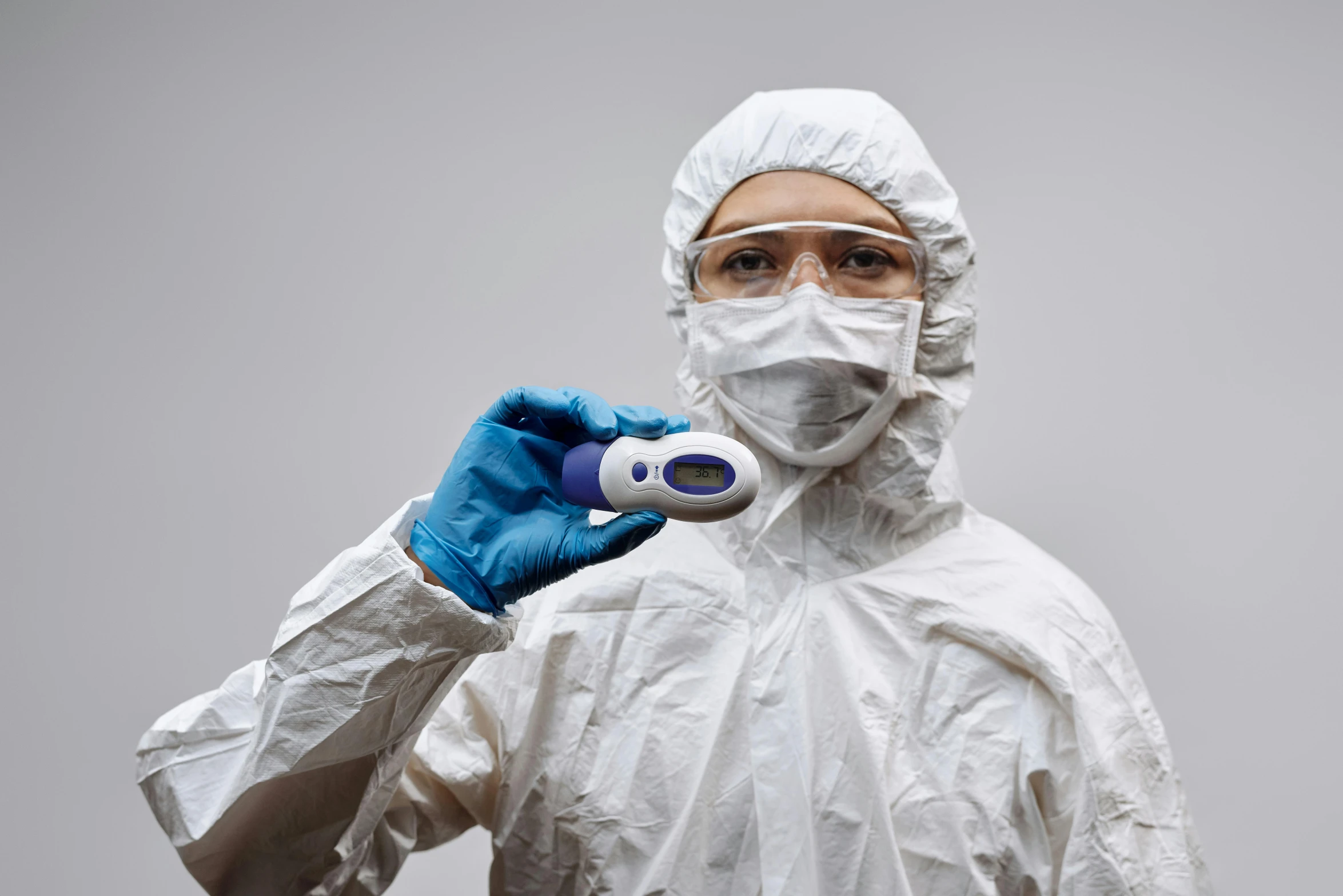 a man in a protective suit brushing his teeth, a portrait, by Adam Marczyński, shutterstock, holding controller, avatar image, medical equipment, cold temperature