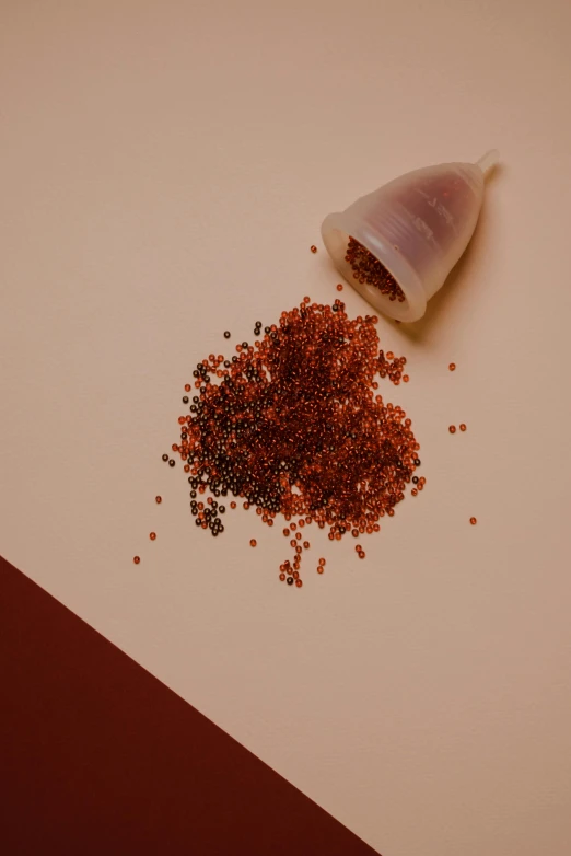 a piece of meat sitting on top of a table, trending on pexels, pointillism, red!! sand, maroon red, cone shaped, miniature product photo