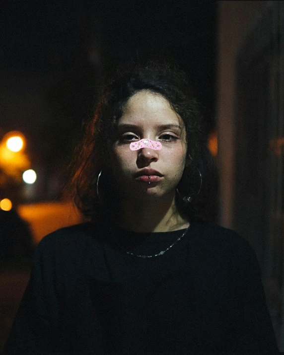 a woman with a pink flower on her nose, an album cover, inspired by Elsa Bleda, pexels contest winner, graffiti, at nighttime, trans rights, 🤤 girl portrait, boyish face