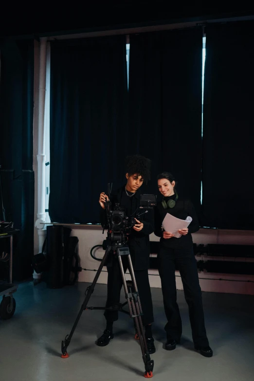 a couple of people standing in front of a camera, by Nina Hamnett, top production, charli bowater and artgeem, looking down on the camera, production ig