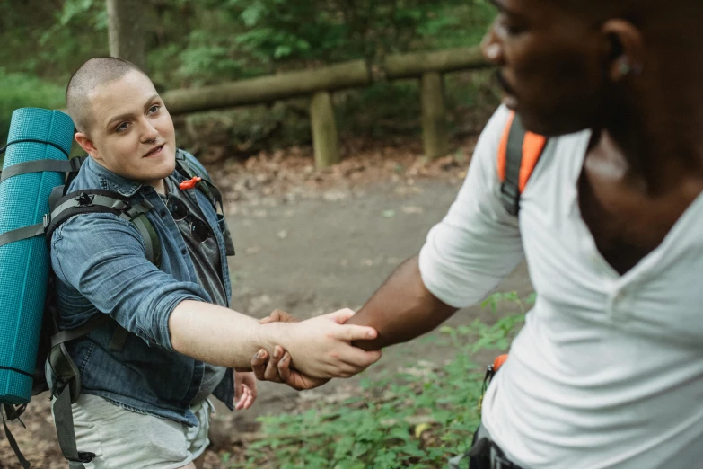 a man shaking another man's hand in the woods, by Emma Andijewska, diverse, charli bowater and artgeem, promo image, male and female