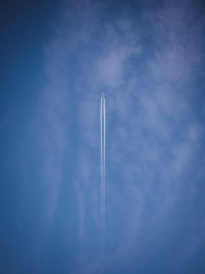 a large jetliner flying through a blue sky, by Matthias Weischer, pexels contest winner, postminimalism, rocket launch, rinko kawauchi, straight smooth vertical, sky high level of alcoholism