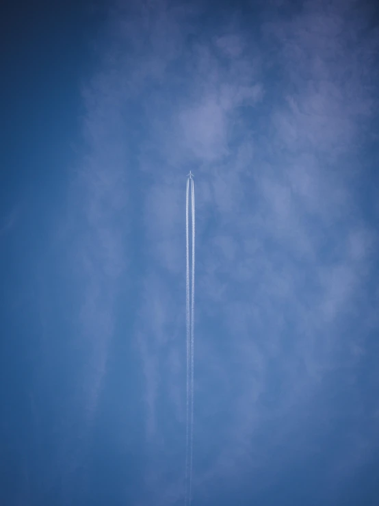 a large jetliner flying through a blue sky, by Matthias Weischer, pexels contest winner, postminimalism, rocket launch, rinko kawauchi, straight smooth vertical, sky high level of alcoholism