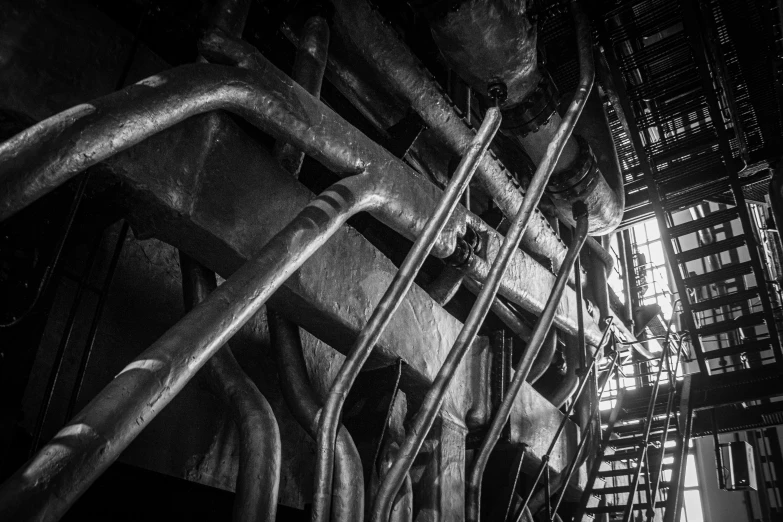 a black and white photo of the inside of a building, by Kristian Zahrtmann, unsplash, art nouveau, industrial rusty pipes, in a nuclear submarine, high details photo, cables