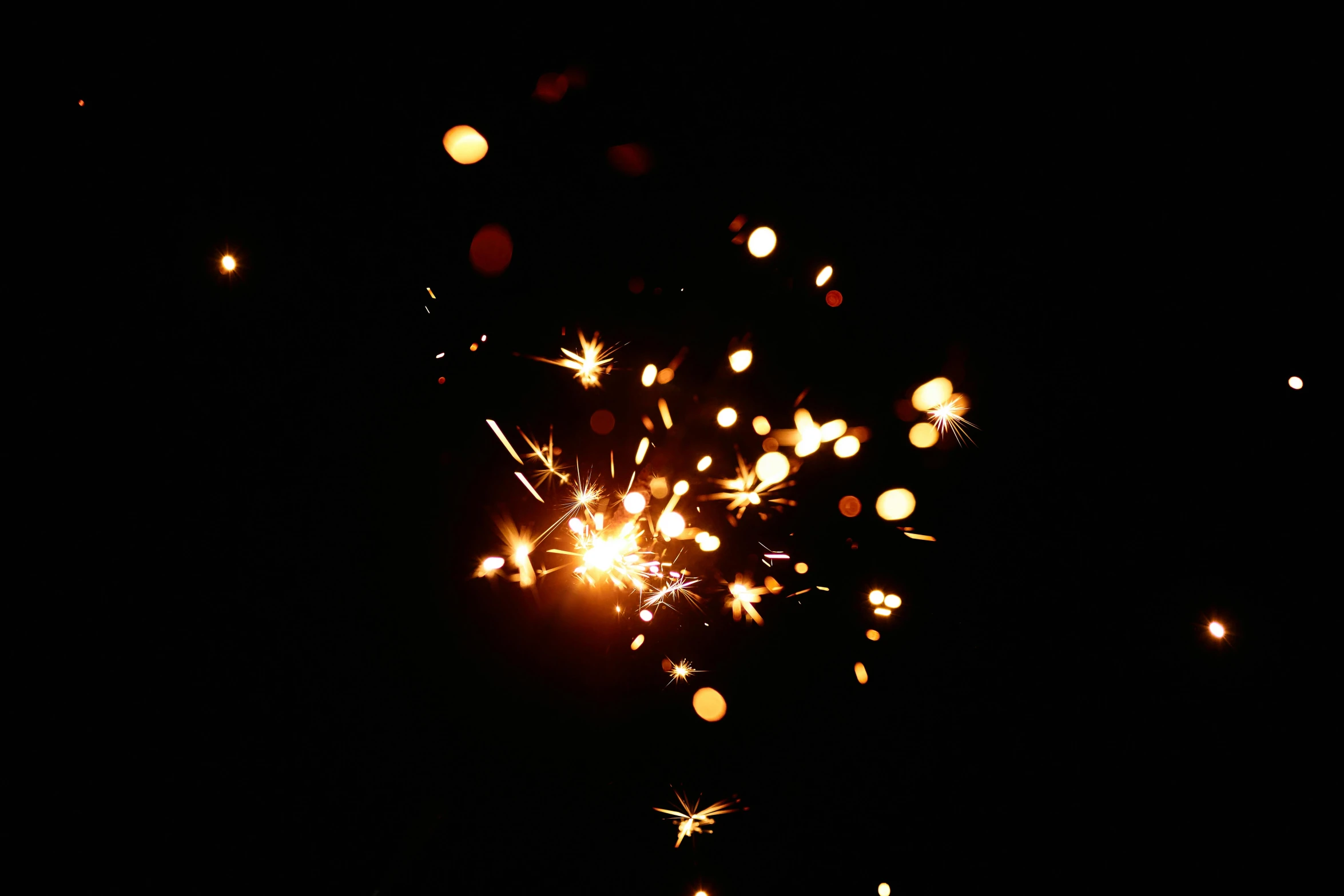 a close up of a sparkler in the dark, pexels, light and space, shining gold and black and red, instagram post, bokeh. i