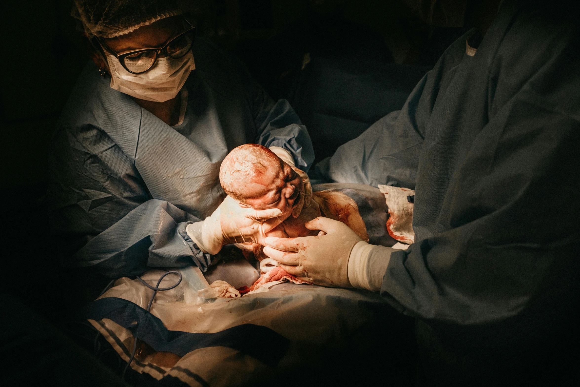 a close up of a person holding a baby, surgery, frank moth, thumbnail, full body image