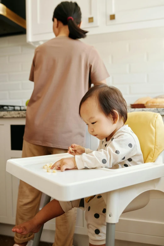 a baby sitting in a high chair in a kitchen, pexels contest winner, process art, jakarta, white and yellow scheme, brown, crispy quality