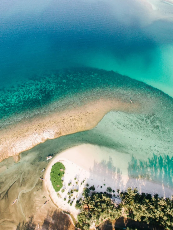 an aerial view of an island in the middle of the ocean, pexels contest winner, hurufiyya, in a beachfront environment, cyan and green, thumbnail, calmly conversing 8k