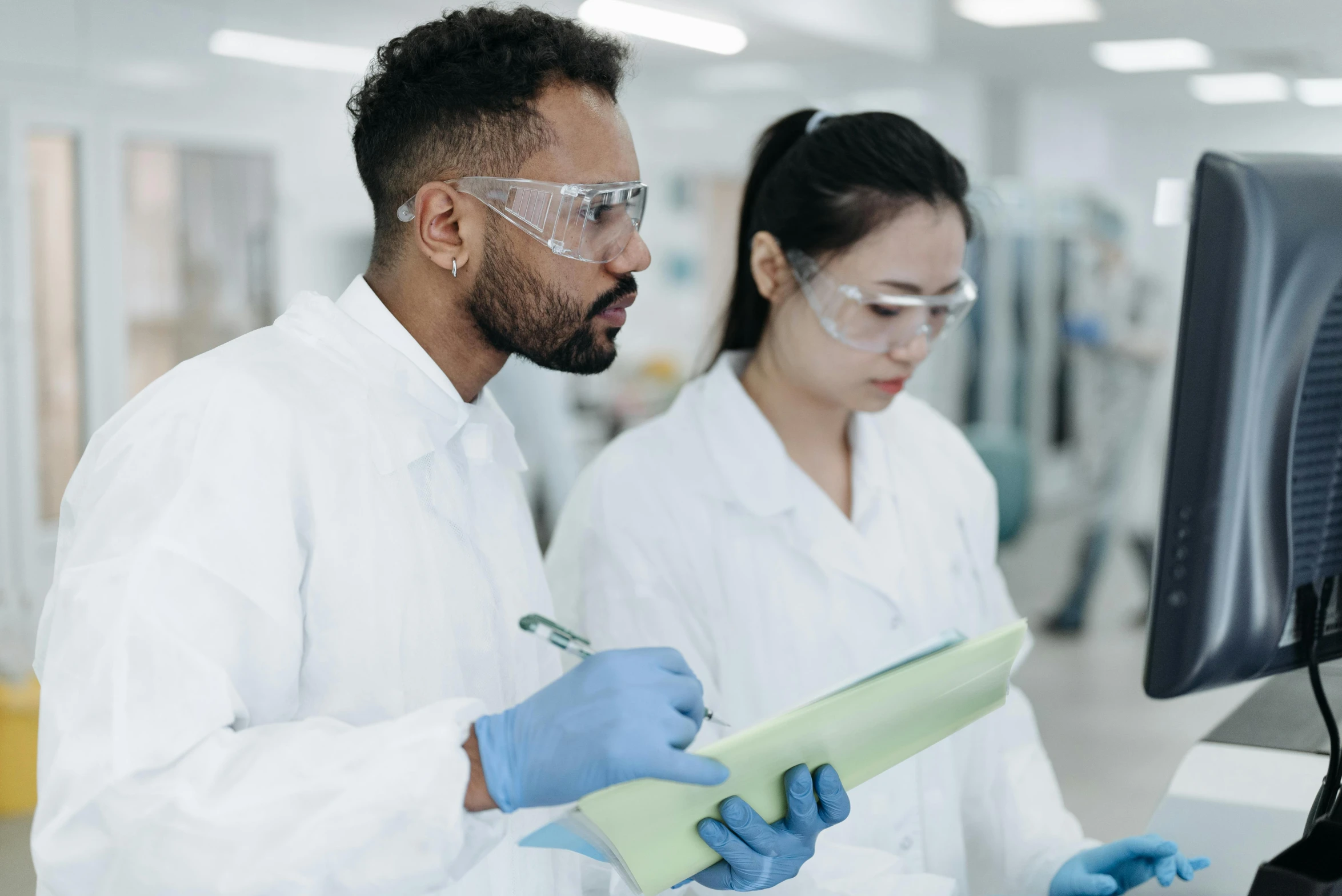 a couple of people standing in front of a computer, reagents, holding a clipboard, te pae, thumbnail