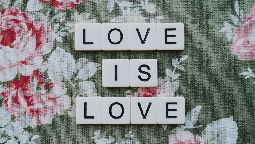 scrabbles spelling love is love on a floral background, pixabay, avatar image, vintage aesthetic, shot on canon eos r 5, 1 6 x 1 6