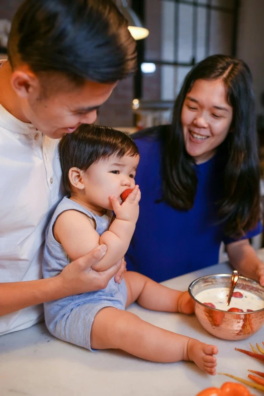 a man and woman sitting at a table with a baby, pexels contest winner, baking cookies, portrait of modern darna, cream, premium quality