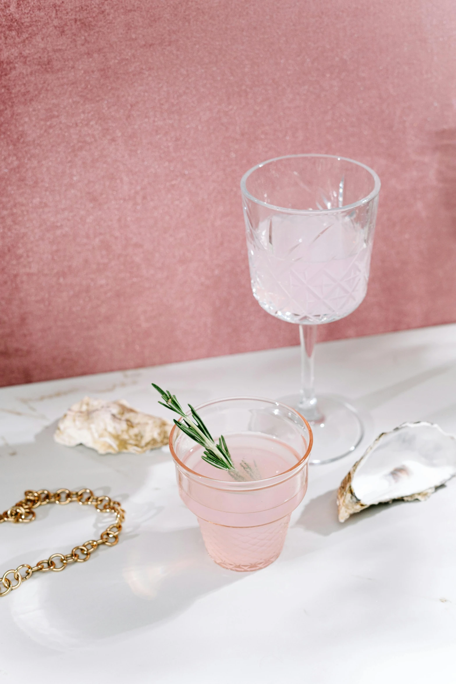 a couple of glasses sitting on top of a table, a still life, inspired by Henriette Grindat, trending on pexels, diamond and rose quartz, with a drink, saltwater, detailed product shot