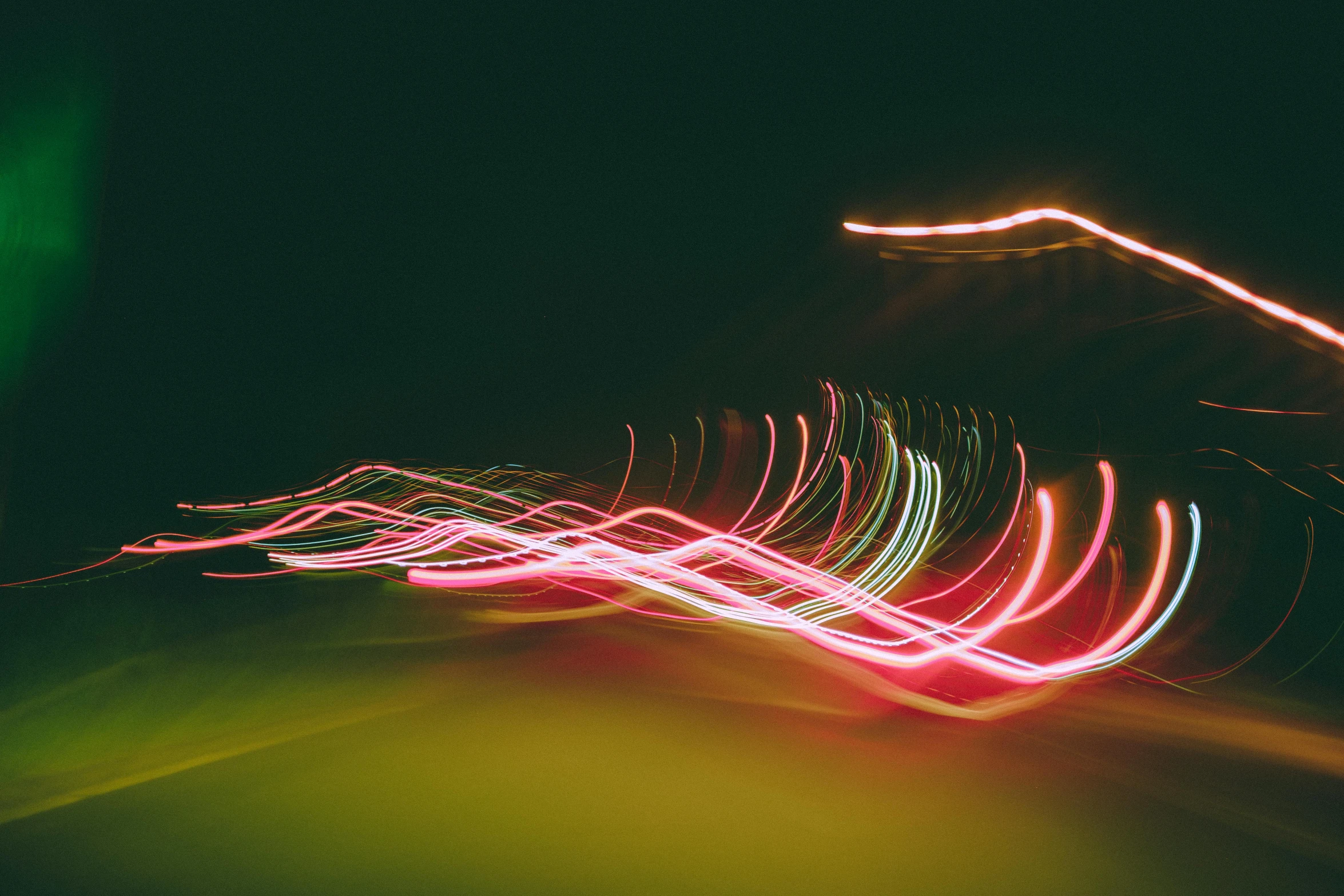 a blurry photo of a street at night, by Carey Morris, pexels, light and space, swirly vibrant color lines, rippling electromagnetic, car lights, low angle photograph