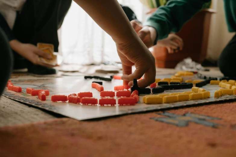 a group of people playing a game of domino, by Jessie Algie, pexels contest winner, visual art, warm coloured, township, on a canva, kids playing