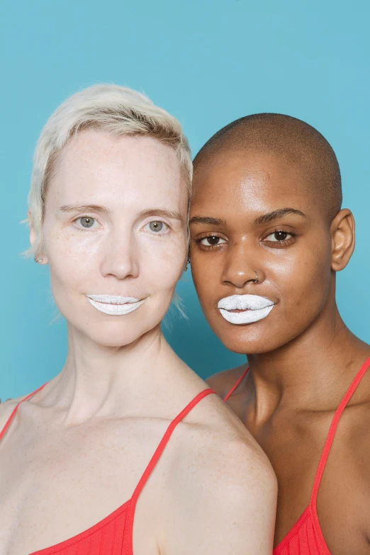 a couple of women standing next to each other, inspired by Vanessa Beecroft, unsplash, white powder makeup, plush lips, in the style of john baldessari, bald lines