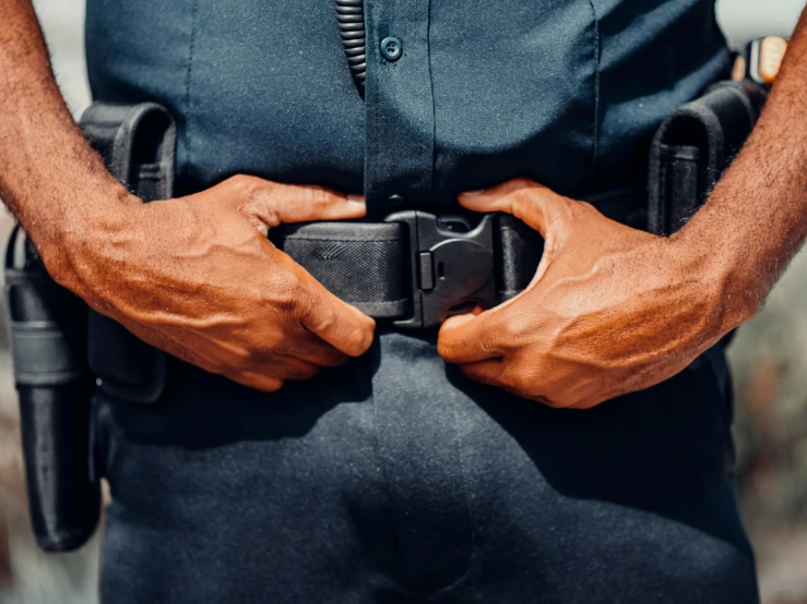 a close up of a police officer's belt, unsplash, symbolism, man in dark blue full body suit, 🦩🪐🐞👩🏻🦳, hands not visible, diverse