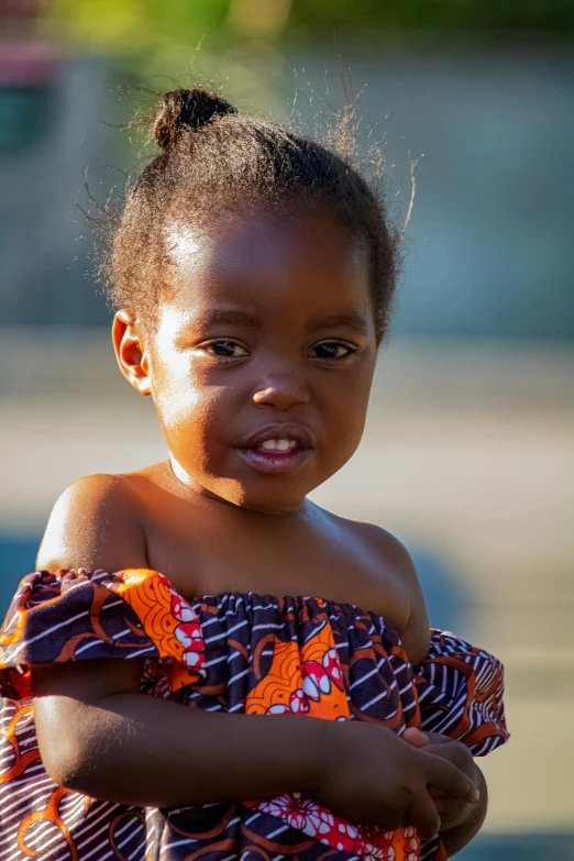 a little girl standing next to a fire hydrant, pexels contest winner, wearing an african dress, wide neck, good face, square