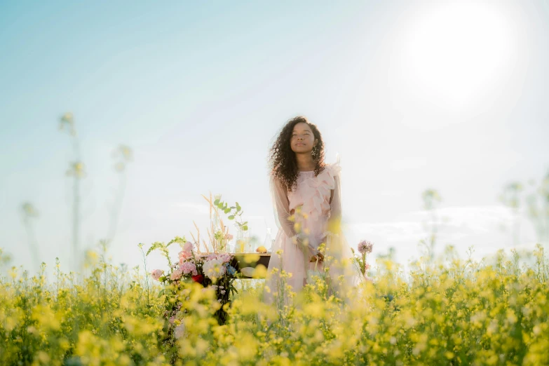 a woman standing in a field of flowers, a picture, by Winona Nelson, pexels contest winner, dafne keen, ashteroth, manuka, mid morning lighting