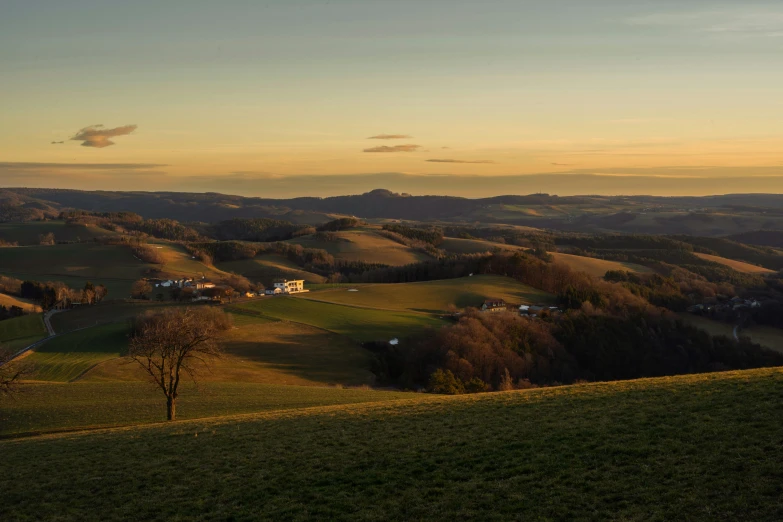 a person flying a kite on top of a lush green hillside, by Tobias Stimmer, pexels contest winner, renaissance, sunset panorama, wide view of a farm, winter sun, soft evening lighting