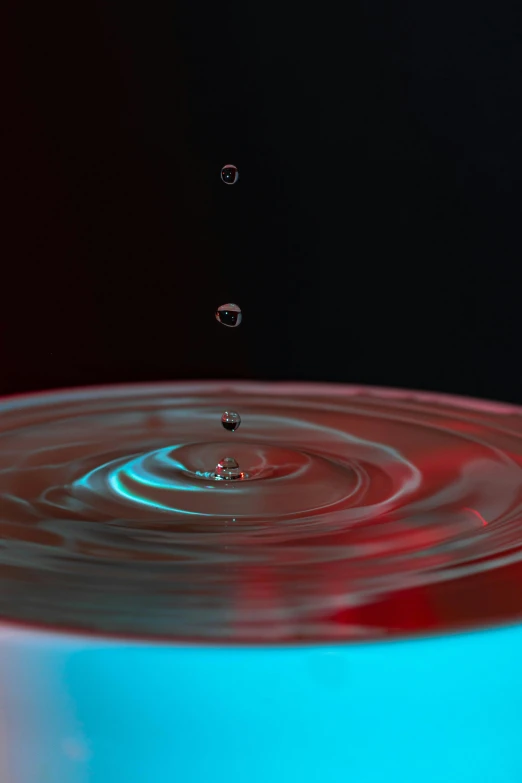 a water drop falling into a blue bowl, an album cover, pexels, digital art, red water, paul barson, ripple effect, hydration
