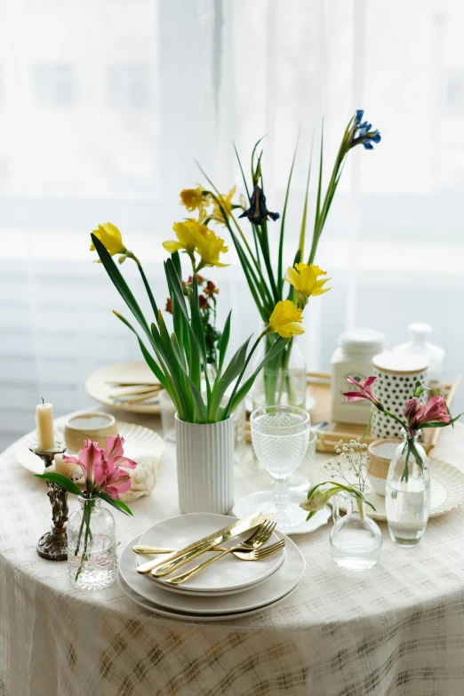 a table that has a bunch of flowers on it, lilies and daffodils, soft natural light, rosenthal, lighthearted celebration