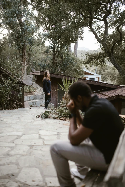 a man sitting on a bench talking on a cell phone, malibu canyon, man and woman walking together, standing outside a house, heartbreak