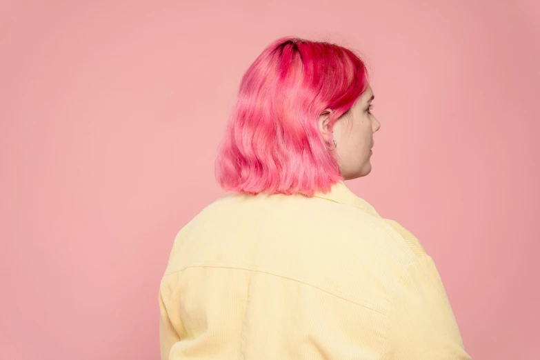 a woman with pink hair wearing a yellow jacket, an album cover, inspired by Elsa Bleda, trending on pexels, realism, view from the side, rex orange county, gradient pink, medium shot taken from behind