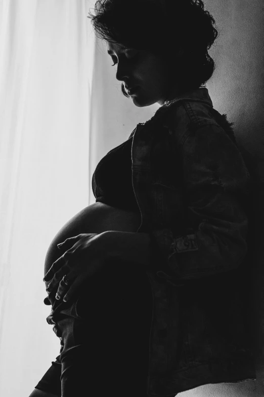 a black and white photo of a pregnant woman, by Lucia Peka, pexels contest winner, ☁🌪🌙👩🏾, with backlight, son, illustration:.4