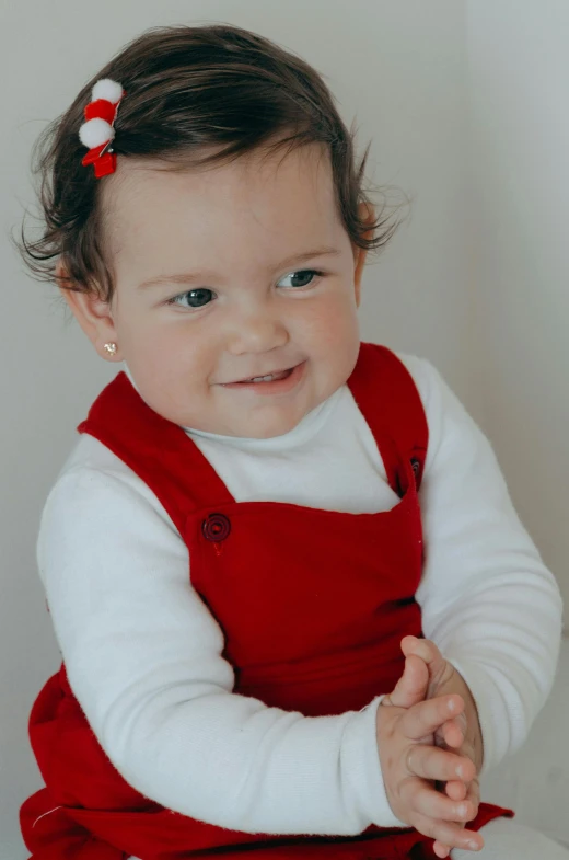 a close up of a baby wearing a red dress, modelling, highest quality, red vest, versatile