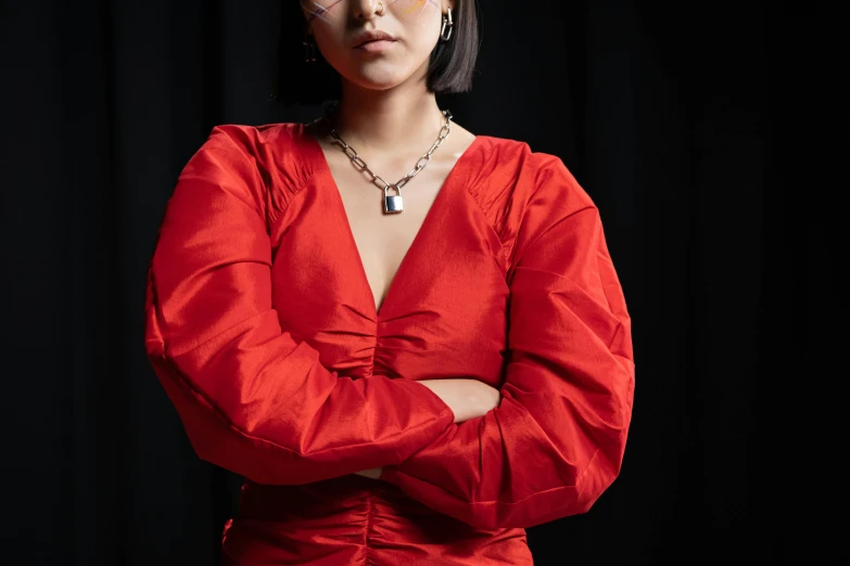 a woman in a red dress posing for a picture, an album cover, trending on pexels, hurufiyya, cyber necklace, magdalena andersson, louise zhang, puff sleeves