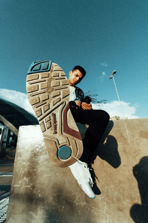 a man riding a skateboard up the side of a ramp, a picture, by Niko Henrichon, nike air max, bottom view ， bladerunner, diego fernandez, teals