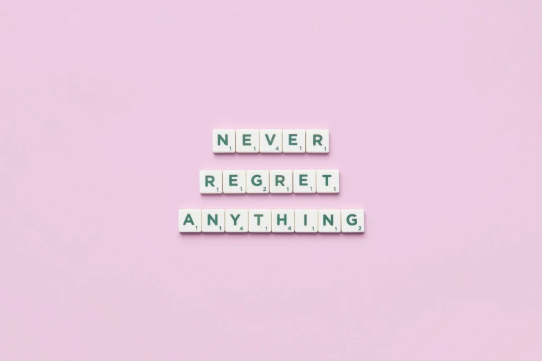 a pink background with the words never regret anything, a picture, trending on pexels, aestheticism, no bricks, set pieces, inspirational quote, magnetic