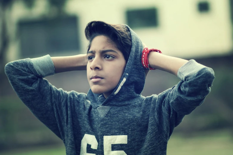 a close up of a person wearing a hoodie, trending on pexels, 14 yo berber boy, depressed dramatic bicep pose, gauged ears, (beautiful) girl