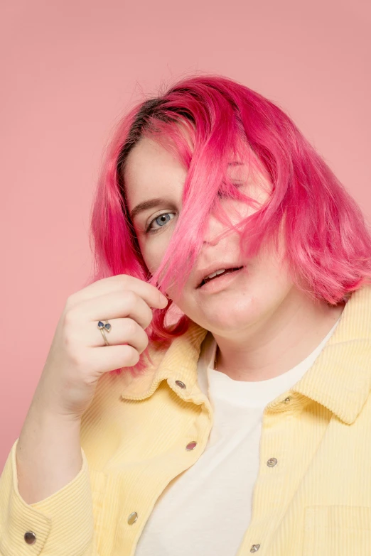 a woman with pink hair wearing a yellow shirt, an album cover, trending on pexels, beth harmon, ((pink)), max prentis, lgbtq