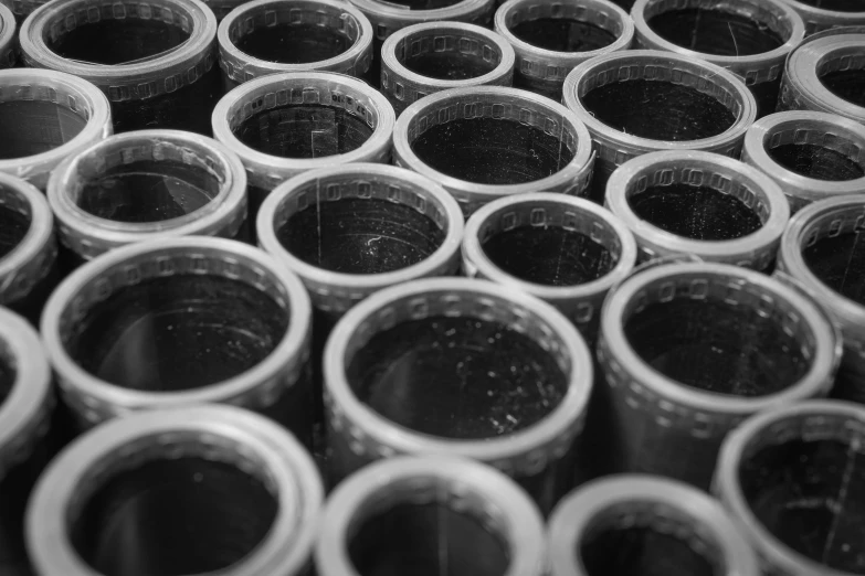 a black and white photo of buckets of paint, a picture, by Stefan Gierowski, op art, macro lense, many pipes, medium format, rings