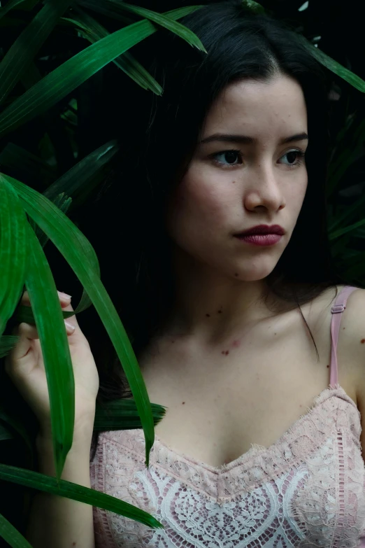 a woman in a pink bra top posing for a picture, inspired by Elsa Bleda, reddit, lush rainforest, kiko mizuhara, 8k 28mm cinematic photo, leafs