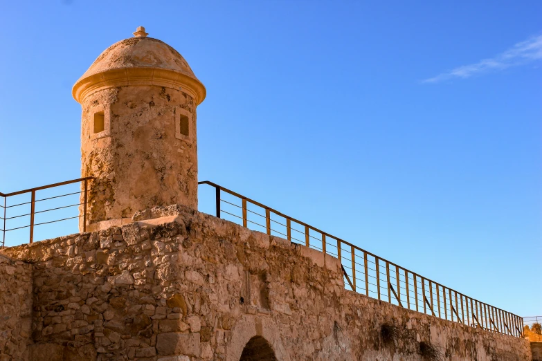 a tall tower sitting on top of a stone building, by Jean Xceron, pexels contest winner, les nabis, costa blanca, historically accurate, rusty, doric