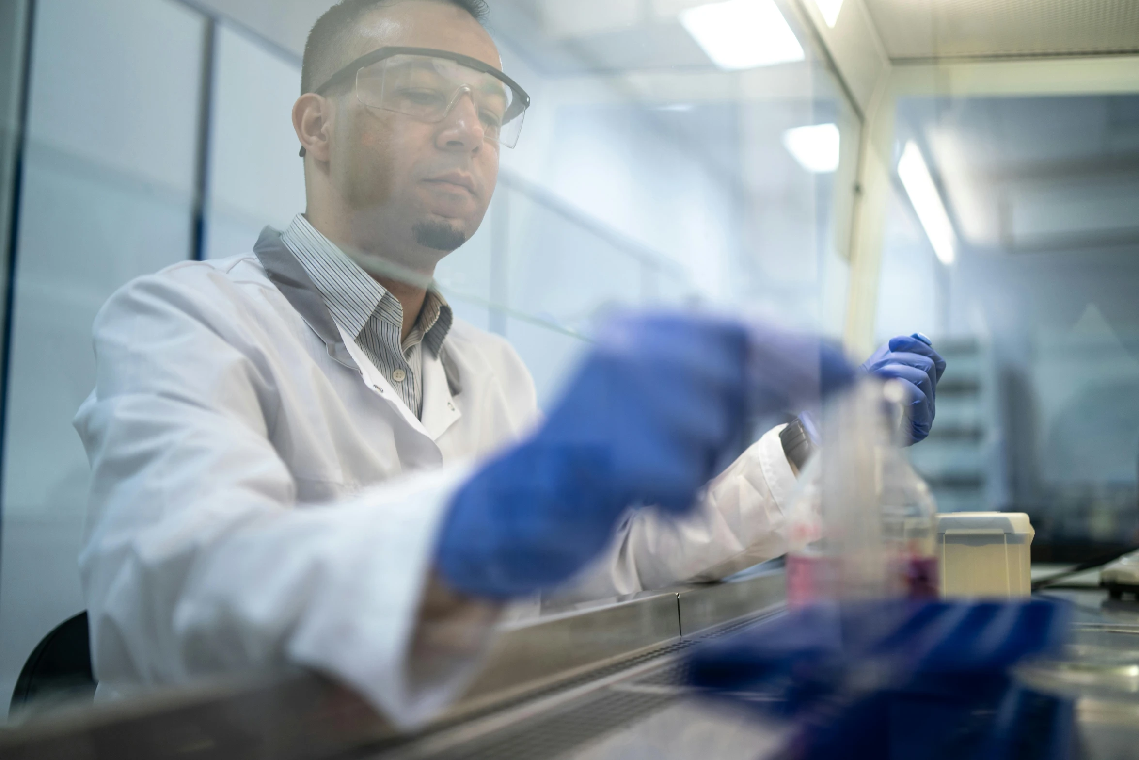 a man in a lab coat and blue gloves, a picture, highly focused, riyahd cassiem, avatar image, maintenance