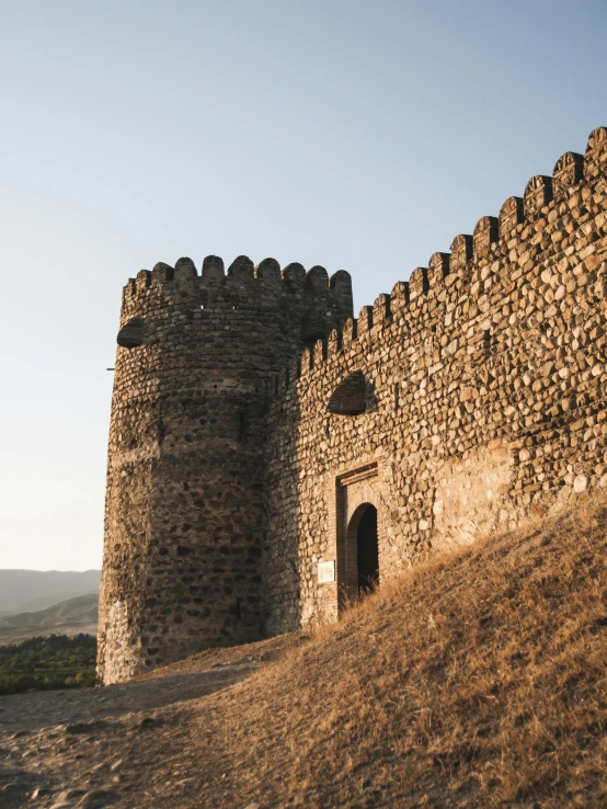 a stone building sitting on top of a hill, walls, moorish architecture, fan favorite, fortresses