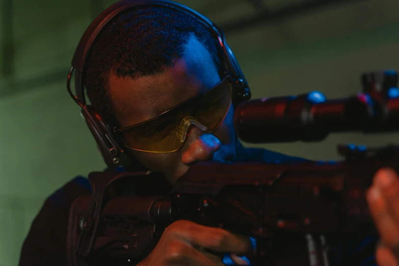 a close up of a person holding a gun, wearing gaming headset, performance, jemal shabazz, combat goggles