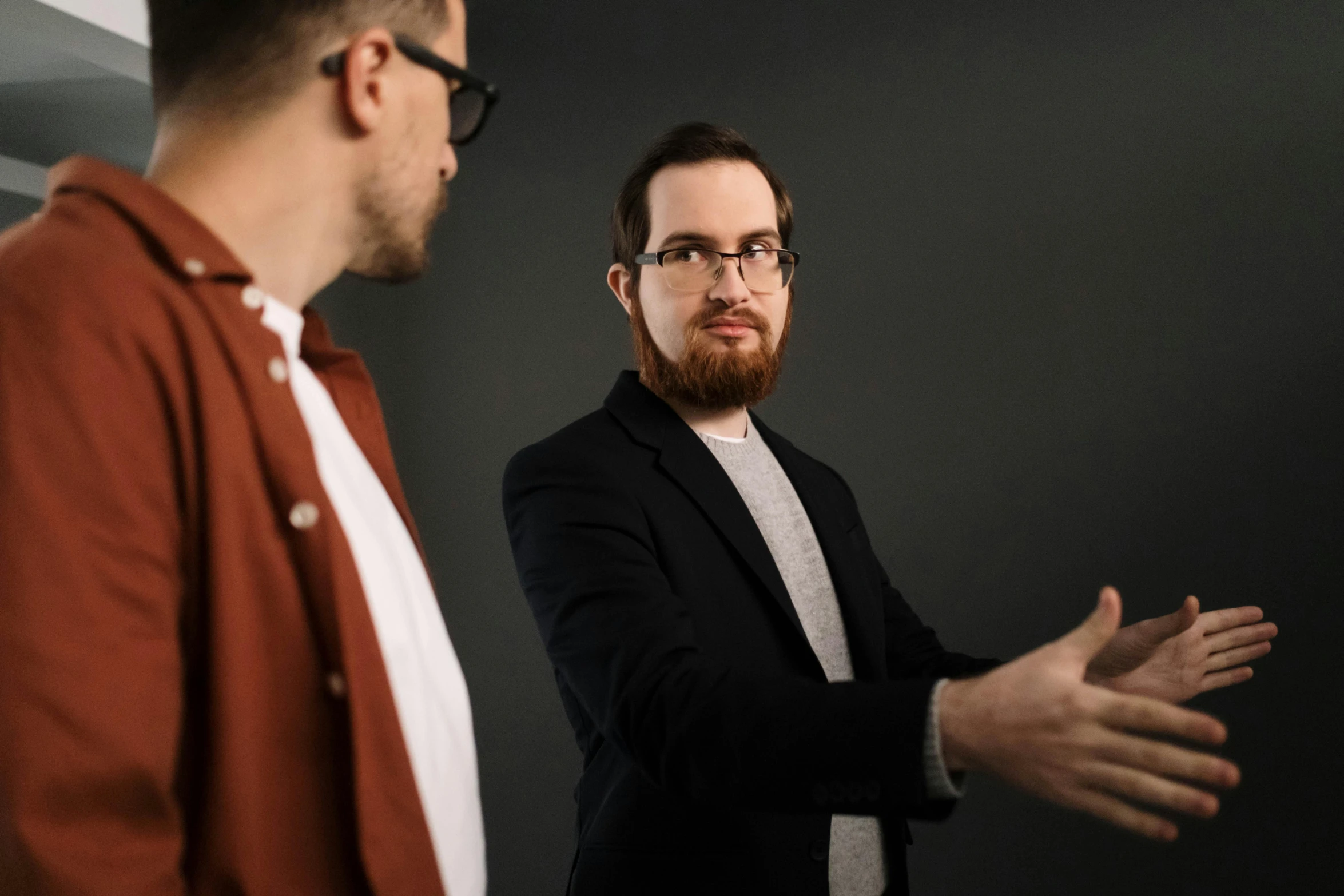 a couple of men standing next to each other, by Adam Marczyński, professional profile picture, hand gestures, ginger bearded man with glasses, dark people discussing